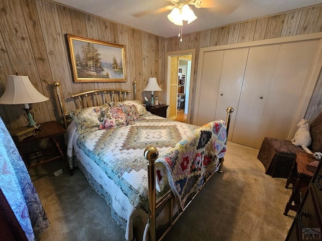 103 S Goff St, Eads, CO 81036 - carpeted bedroom with wood walls, a closet, and ceiling fan