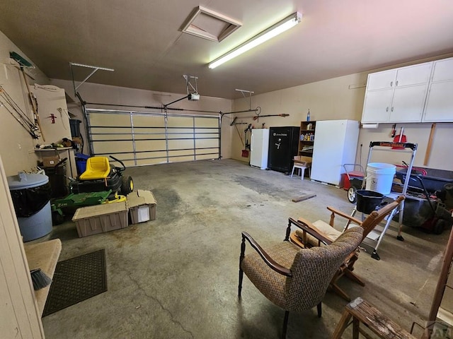 103 S Goff St, Eads, CO 81036 - garage featuring freestanding refrigerator and a garage door opener