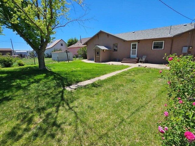 103 S Goff St, Eads, CO 81036 - view of green lawn featuring a patio area