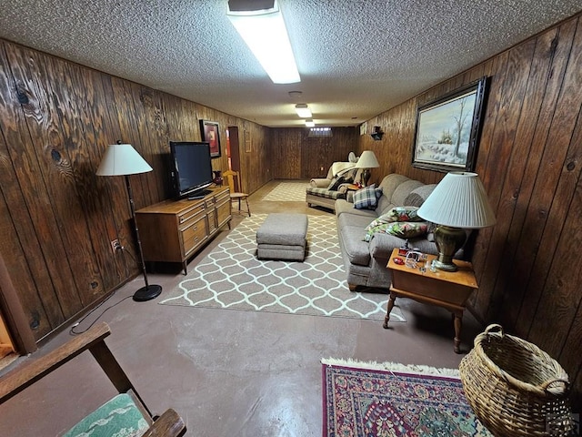 103 S Goff St, Eads, CO 81036 - living room featuring wood walls, a textured ceiling, and concrete floors