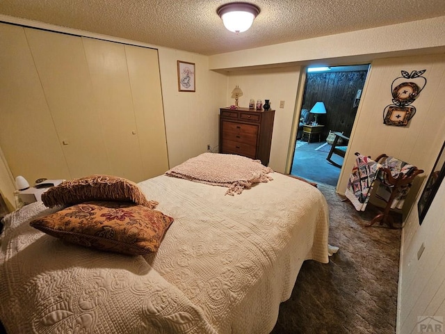 103 S Goff St, Eads, CO 81036 - bedroom with carpet, access to outside, a textured ceiling, and a closet