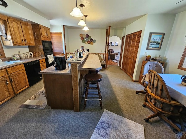 103 S Goff St, Eads, CO 81036 - kitchen featuring black appliances, light carpet, a center island, a sink, and hanging light fixtures