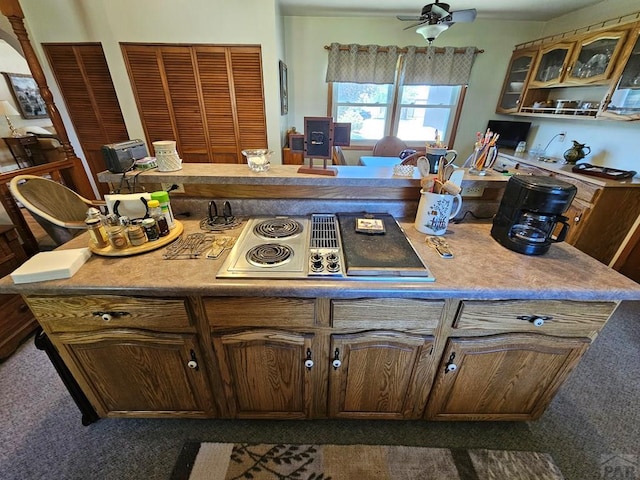 103 S Goff St, Eads, CO 81036 - kitchen featuring stainless steel electric cooktop, dark carpet, glass insert cabinets, and light countertops