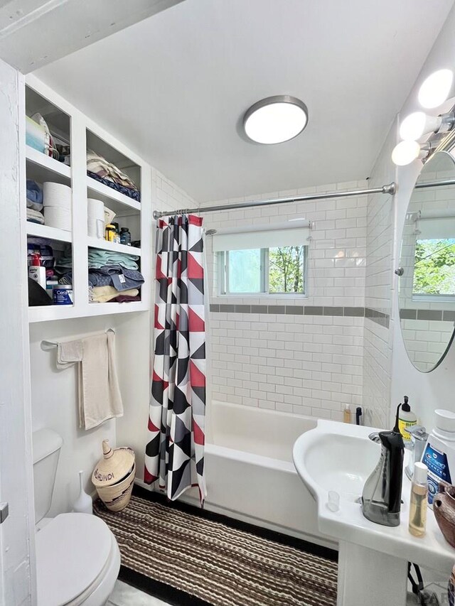 full bath featuring shower / tub combo and toilet