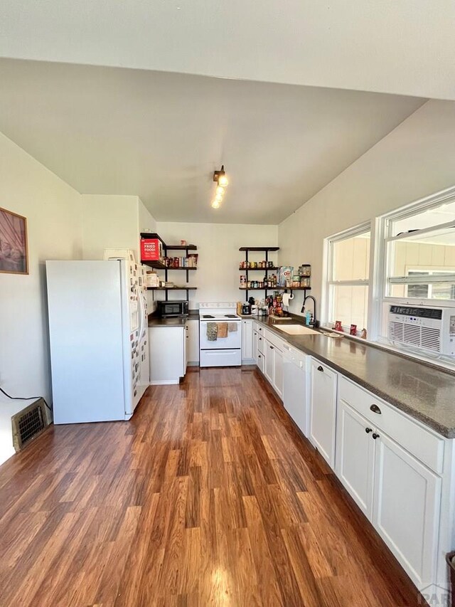 kitchen featuring white appliances, visible vents, dark wood finished floors, dark countertops, and white cabinetry