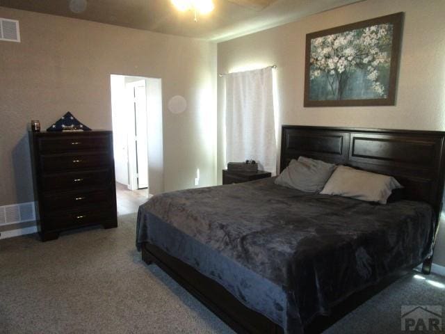 bedroom with visible vents and carpet