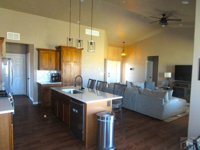 kitchen featuring dark wood-style floors, a sink, ceiling fan, high vaulted ceiling, and dishwasher