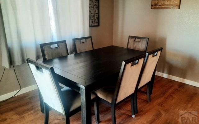 dining room with wood finished floors and baseboards