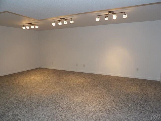 empty room featuring carpet flooring and baseboards