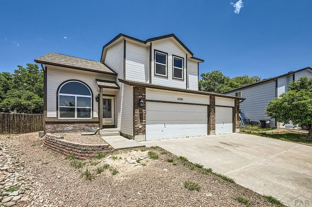 4366 Witches Hollow Ln, Colorado Springs, CO 80911 - traditional-style home with brick siding, driveway, and a garage