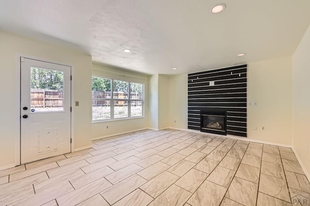 4366 Witches Hollow Ln, Colorado Springs, CO 80911 - unfurnished living room with recessed lighting and a large fireplace