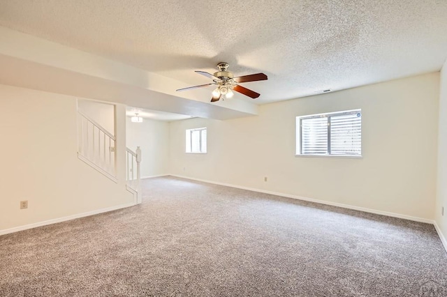 4366 Witches Hollow Ln, Colorado Springs, CO 80911 - carpeted spare room with a ceiling fan, stairs, and a textured ceiling
