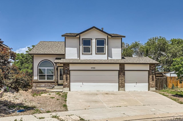 4366 Witches Hollow Ln, Colorado Springs, CO 80911 - view of front of house with brick siding, concrete driveway, a garage, and a shingled roof