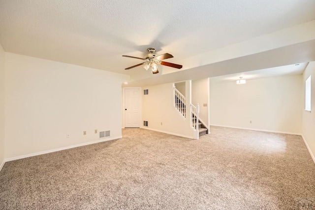 4366 Witches Hollow Ln, Colorado Springs, CO 80911 - spare room featuring stairway, light carpet, a ceiling fan, and a textured ceiling