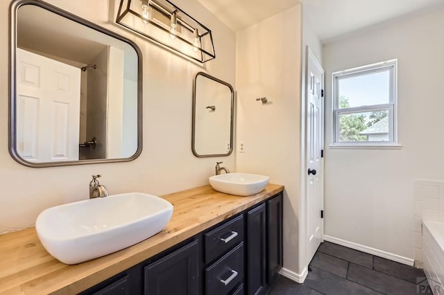 4366 Witches Hollow Ln, Colorado Springs, CO 80911 - bathroom with tile patterned floors, a bath, and double vanity