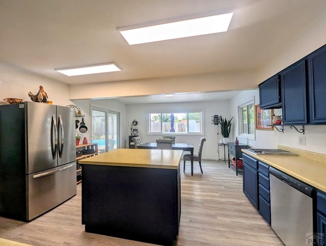 29 Mountview Dr, La Junta, CO 81050 - kitchen featuring stainless steel appliances, blue cabinetry, light countertops, and light wood-style floors