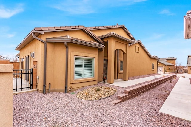 exterior space featuring fence and stucco siding