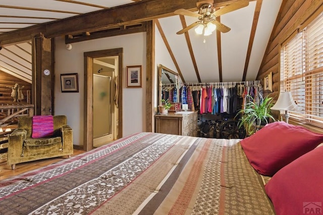 bedroom featuring wood finished floors and lofted ceiling with beams