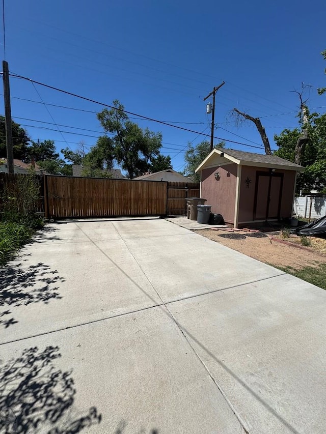 914 Santa Fe, La Junta, CO 81050 - view of patio / terrace featuring a gate, a storage unit, fence, and an outdoor structure
