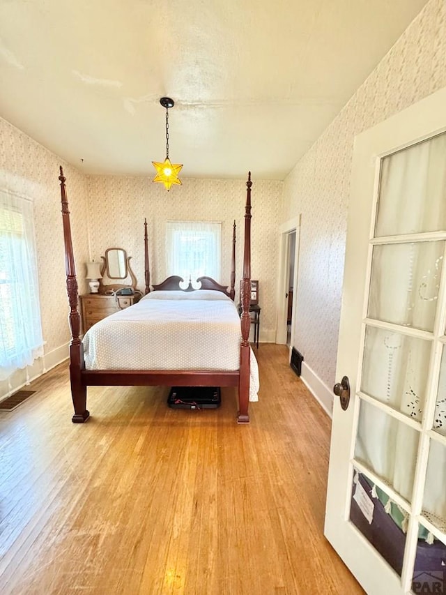 914 Santa Fe, La Junta, CO 81050 - bedroom featuring wallpapered walls, light wood-style flooring, and baseboards