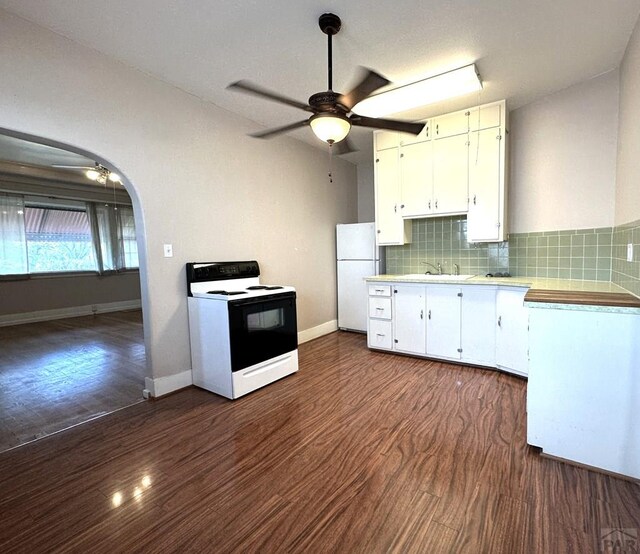 kitchen featuring freestanding refrigerator, white cabinets, light countertops, and range with electric stovetop