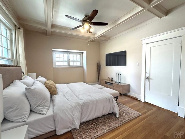 bedroom with dark wood-style floors, ceiling fan, coffered ceiling, beamed ceiling, and baseboards