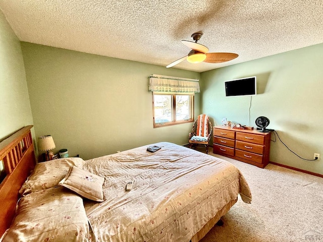 bedroom with carpet floors, a textured ceiling, baseboards, and a ceiling fan