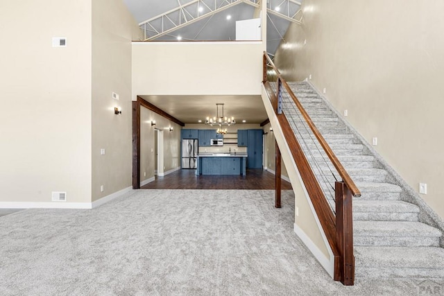 332 Yellow Bird Rd, Rye, CO 81069 - stairway featuring a towering ceiling, carpet flooring, and a chandelier