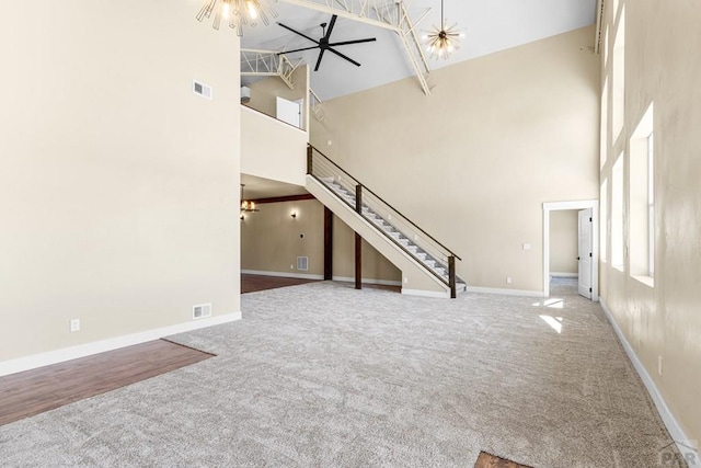 332 Yellow Bird Rd, Rye, CO 81069 - unfurnished living room featuring high vaulted ceiling, carpet floors, stairway, and ceiling fan