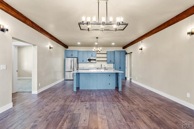 332 Yellow Bird Rd, Rye, CO 81069 - kitchen with blue cabinets, a chandelier, appliances with stainless steel finishes, light countertops, and dark wood-style flooring