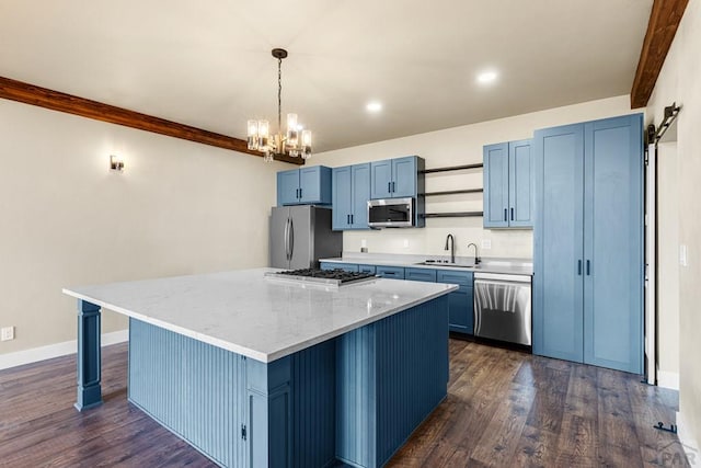 332 Yellow Bird Rd, Rye, CO 81069 - kitchen with appliances with stainless steel finishes, blue cabinets, a chandelier, a kitchen island, and dark wood-style flooring