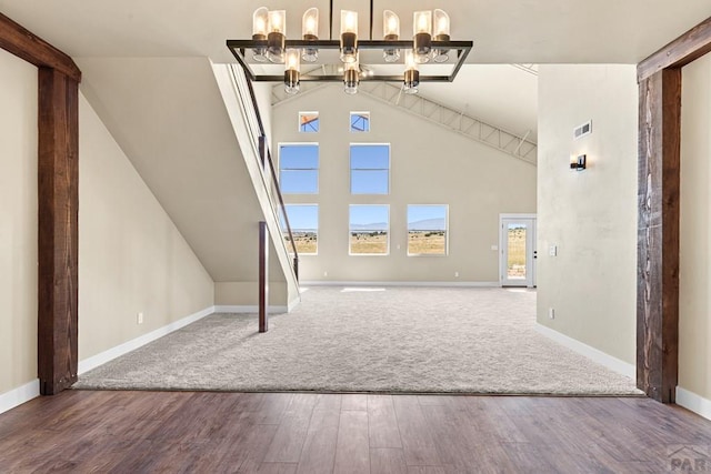 332 Yellow Bird Rd, Rye, CO 81069 - unfurnished living room with wood finished floors, a chandelier, vaulted ceiling, and carpet