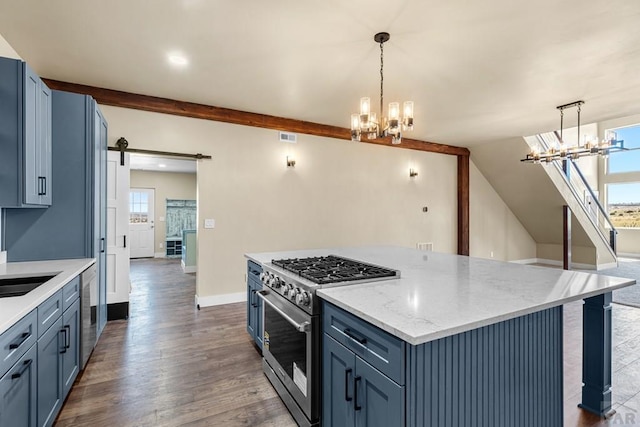 332 Yellow Bird Rd, Rye, CO 81069 - kitchen featuring high end range, a chandelier, dark wood-type flooring, a kitchen island, and a barn door