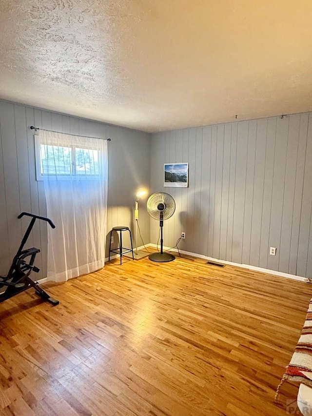 629 Gaylord Ave, Pueblo, CO 81004 - spare room with hardwood / wood-style flooring and wood walls
