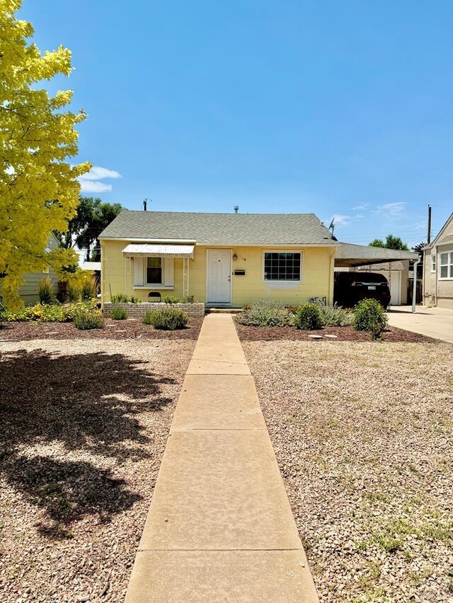 629 Gaylord Ave, Pueblo, CO 81004 - view of front facade featuring a carport, a shingled roof, and concrete driveway