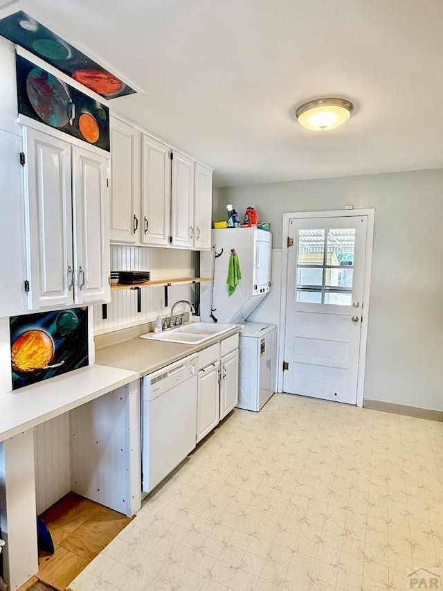 629 Gaylord Ave, Pueblo, CO 81004 - kitchen featuring white dishwasher, stacked washer and clothes dryer, white cabinets, light countertops, and open shelves