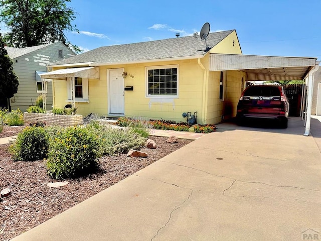 629 Gaylord Ave, Pueblo, CO 81004 - bungalow with roof with shingles, an attached carport, and concrete driveway