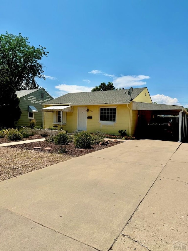 629 Gaylord Ave, Pueblo, CO 81004 - ranch-style house with driveway, a carport, a shingled roof, and concrete block siding