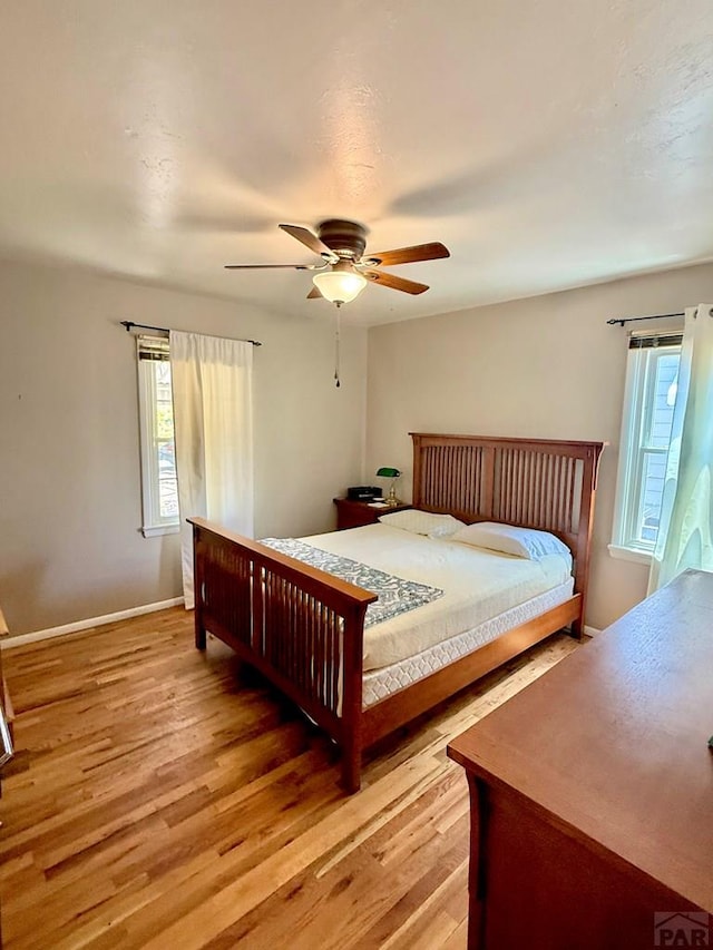 629 Gaylord Ave, Pueblo, CO 81004 - bedroom featuring multiple windows, light wood-type flooring, and a ceiling fan