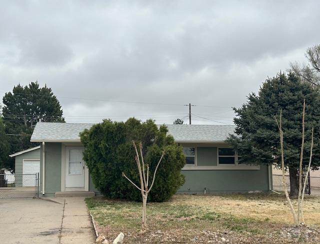 view of front of house with fence, a gate, concrete driveway, and a garage
