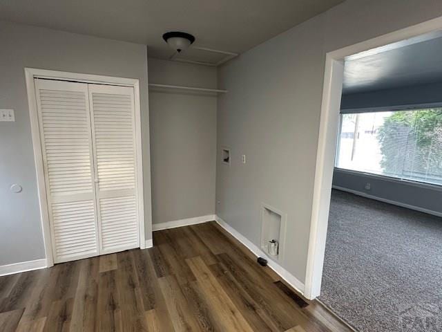 clothes washing area with baseboards, wood finished floors, and washer hookup