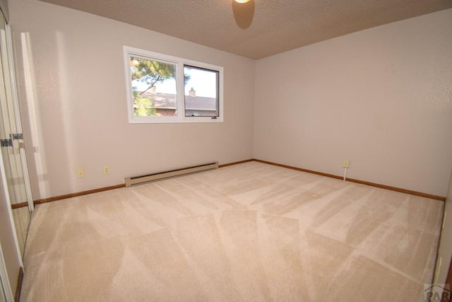 unfurnished room with a ceiling fan, baseboard heating, light carpet, and a textured ceiling