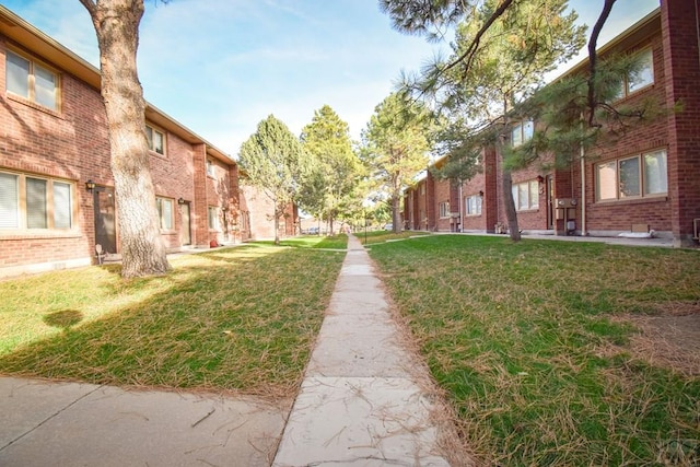 surrounding community with a residential view and a yard