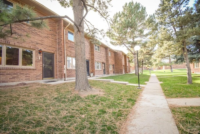 view of home's community with a yard
