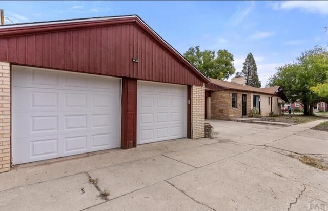 view of front of house featuring a garage and brick siding