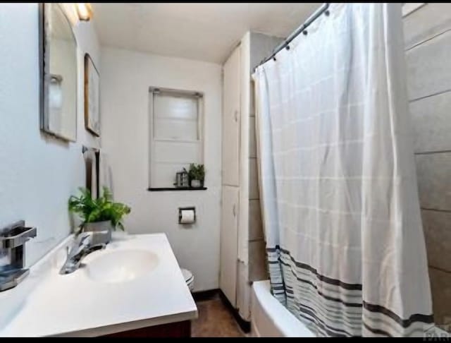 full bath with shower / bath combo with shower curtain and vanity