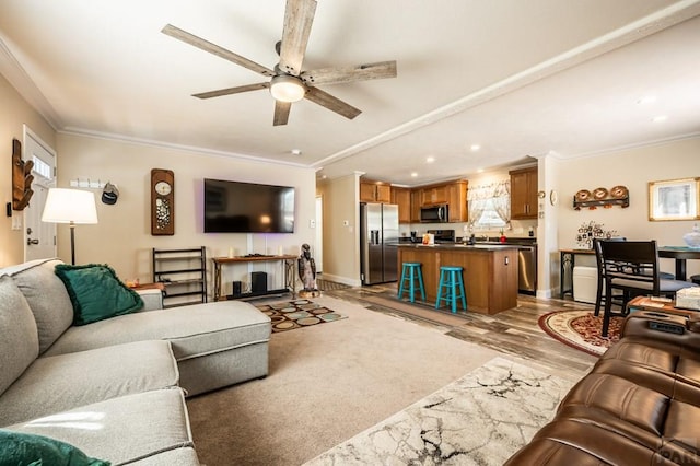 999 Fortino Blvd Unit 33, Pueblo, CO 81008 - living room featuring crown molding, ceiling fan, light wood finished floors, baseboards, and recessed lighting