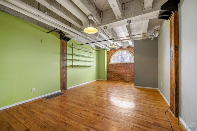 201 Lamkin St Unit 207, Pueblo, CO 81003 - empty room with wood-type flooring and brick wall