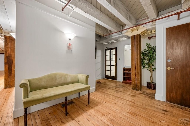 201 Lamkin St Unit 207, Pueblo, CO 81003 - living area featuring light wood-style flooring and a wooden ceiling with exposed beams