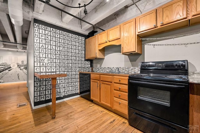 201 Lamkin St Unit 207, Pueblo, CO 81003 - kitchen with black appliances and light wood-style flooring
